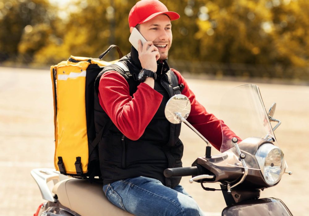 courier-talking-on-mobile-phone-sitting-on-scooter-in-city-1.jpg courier-talking-on-mobile-phone-sitting-on-scooter-in-city-1.jpg